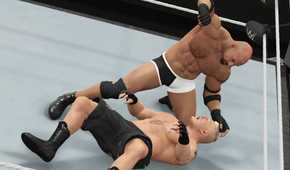 A screenshot from WWE 2K17, showing WWE superstar Goldberg attack Brock Lesnar (black shorts) while he's on the ground.