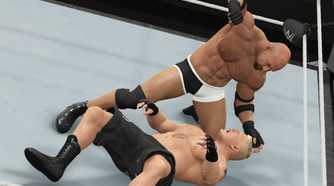 A screenshot from WWE 2K17, showing WWE superstar Goldberg attack Brock Lesnar (black shorts) while he's on the ground.