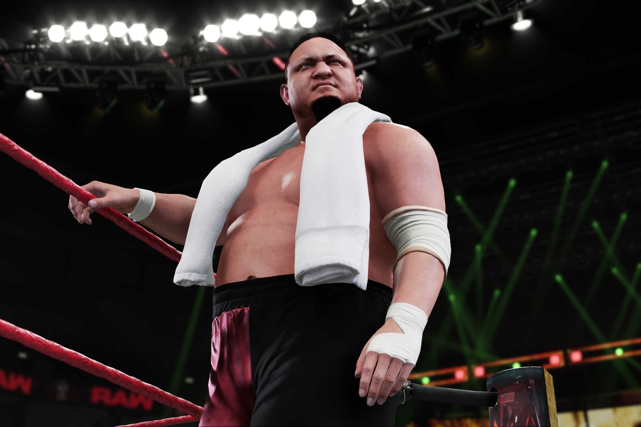 A screenshot from WWE 2K18, showing Samoa Joe make his way to the ring with a white towel around his shoulders.