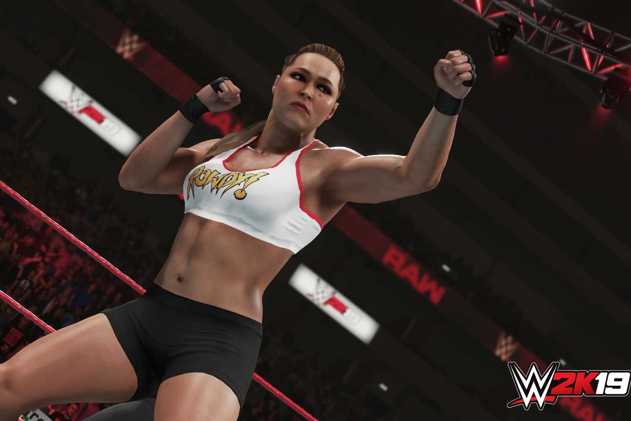 A screenshot from WWE 2K19, showing Rowdy Ronda Rousey taking a boxing stance.