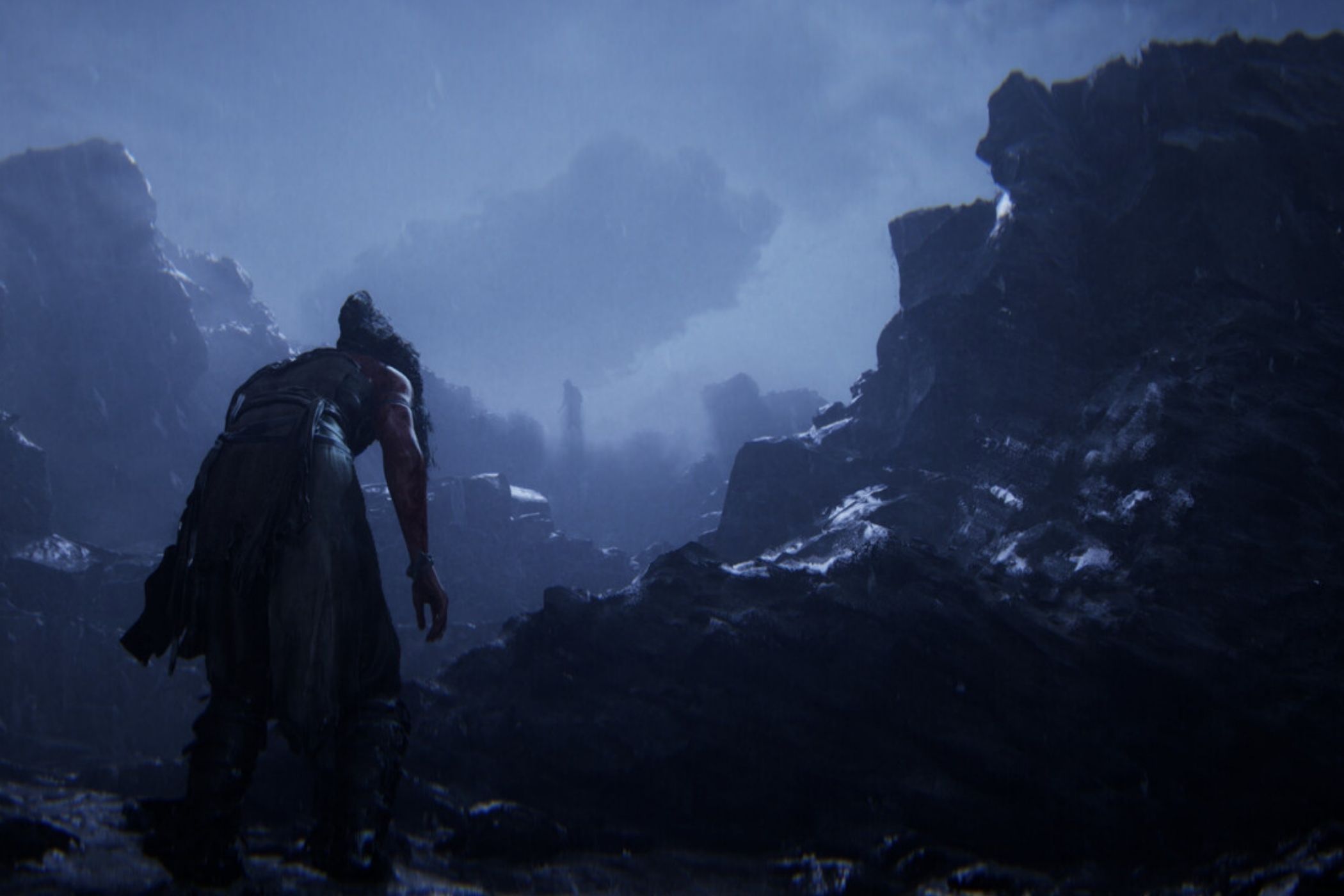 Hellblade 2 Senua walking through rocky cliffs