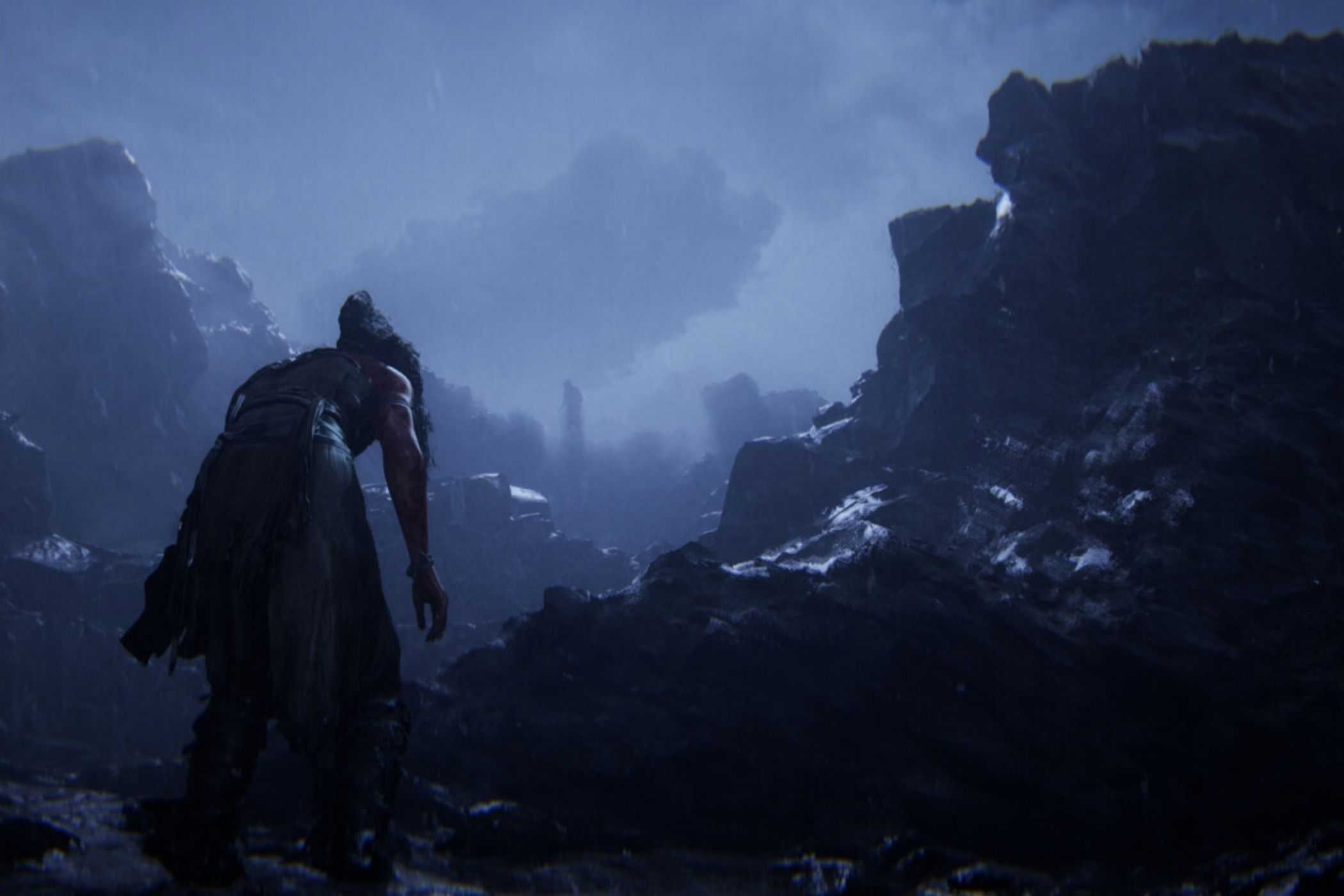 Hellblade 2 Senua walking through rocky cliffs