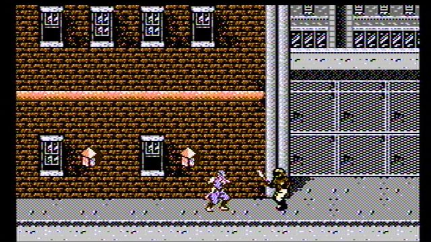 fighting an enemy in a city in Ninja Gaiden