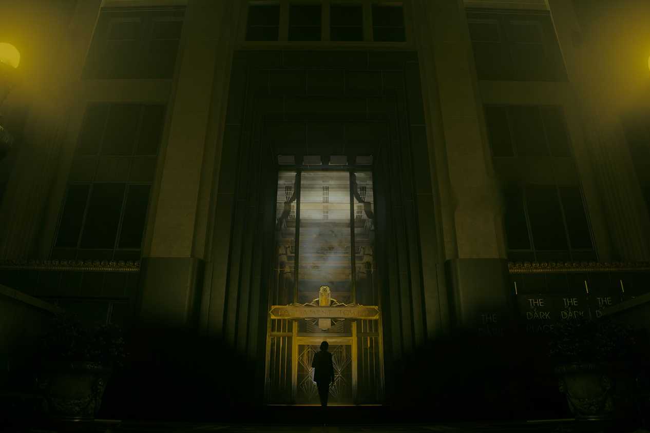 An image from the game "Alan Wake 2", showing a huge building bathed in dim yellow light.