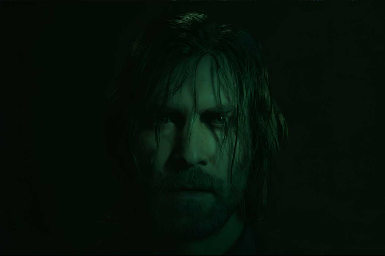 An image from Alan Wake II, showing the protagonist Alan Wake staring into the camera with hair strewn across his face.