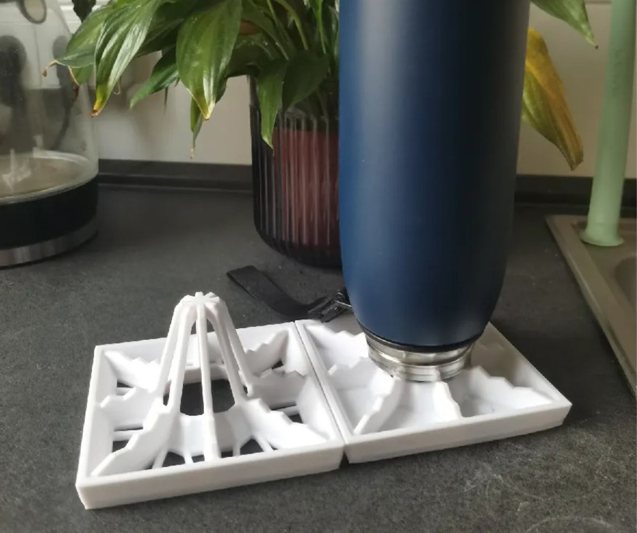 A bottle on top of a drying rack