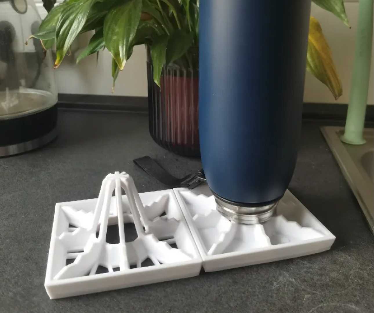 A bottle on top of a drying rack