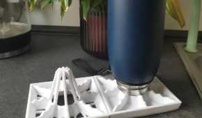A bottle on top of a drying rack