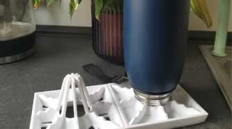 A bottle on top of a drying rack