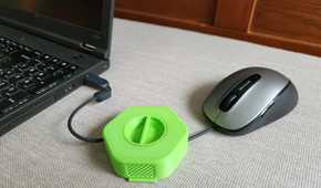 Wire of the mouse inserted inside 3D printed cable organizer