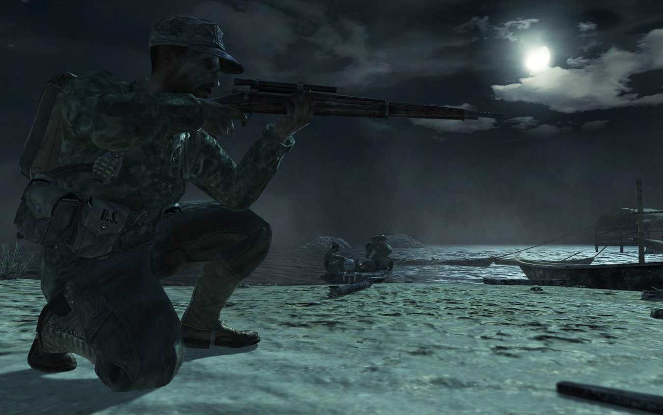 Screenshot from Call of Duty: World at War video game of soldier aiming a rifle at night.