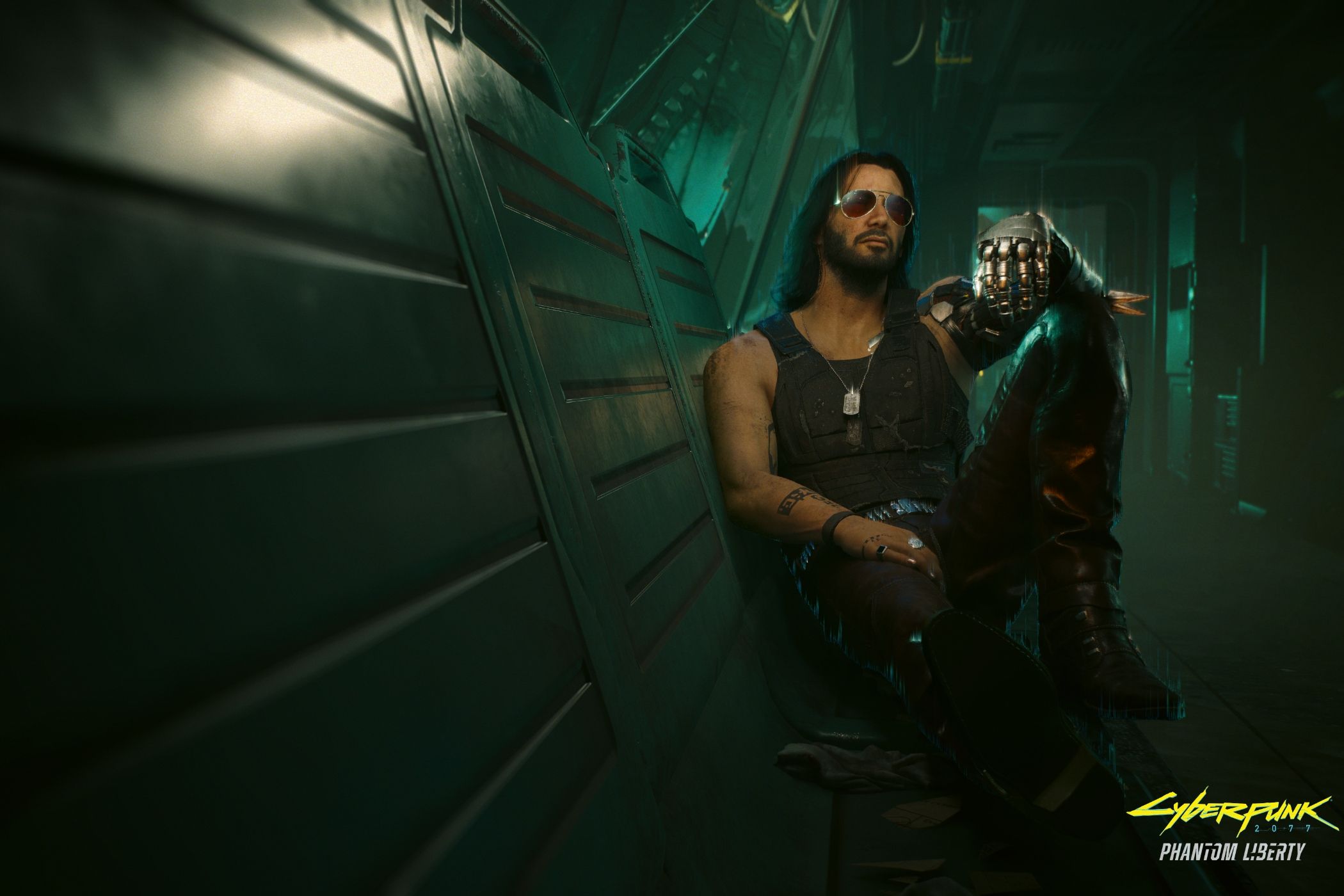 An image from the game "Cyberpunk 2077", showing a man with long hair and sunglasses sitting against a wall in a dimly-lit hallway.
