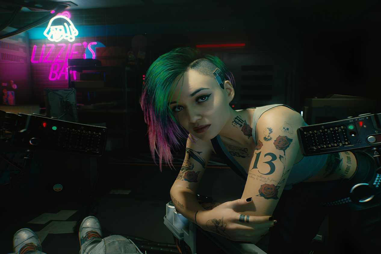 An image from Cyberpunk 2077, showing Judy Alvarez leaning over the protagonist.
