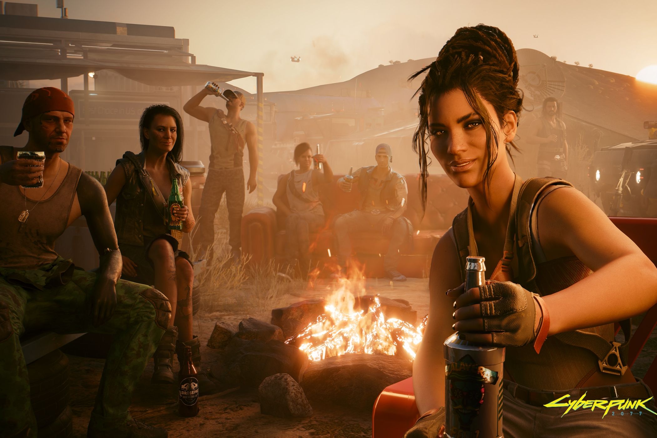 An image from Cyberpunk 2077, showing people itting around a fire and partying with drinks.