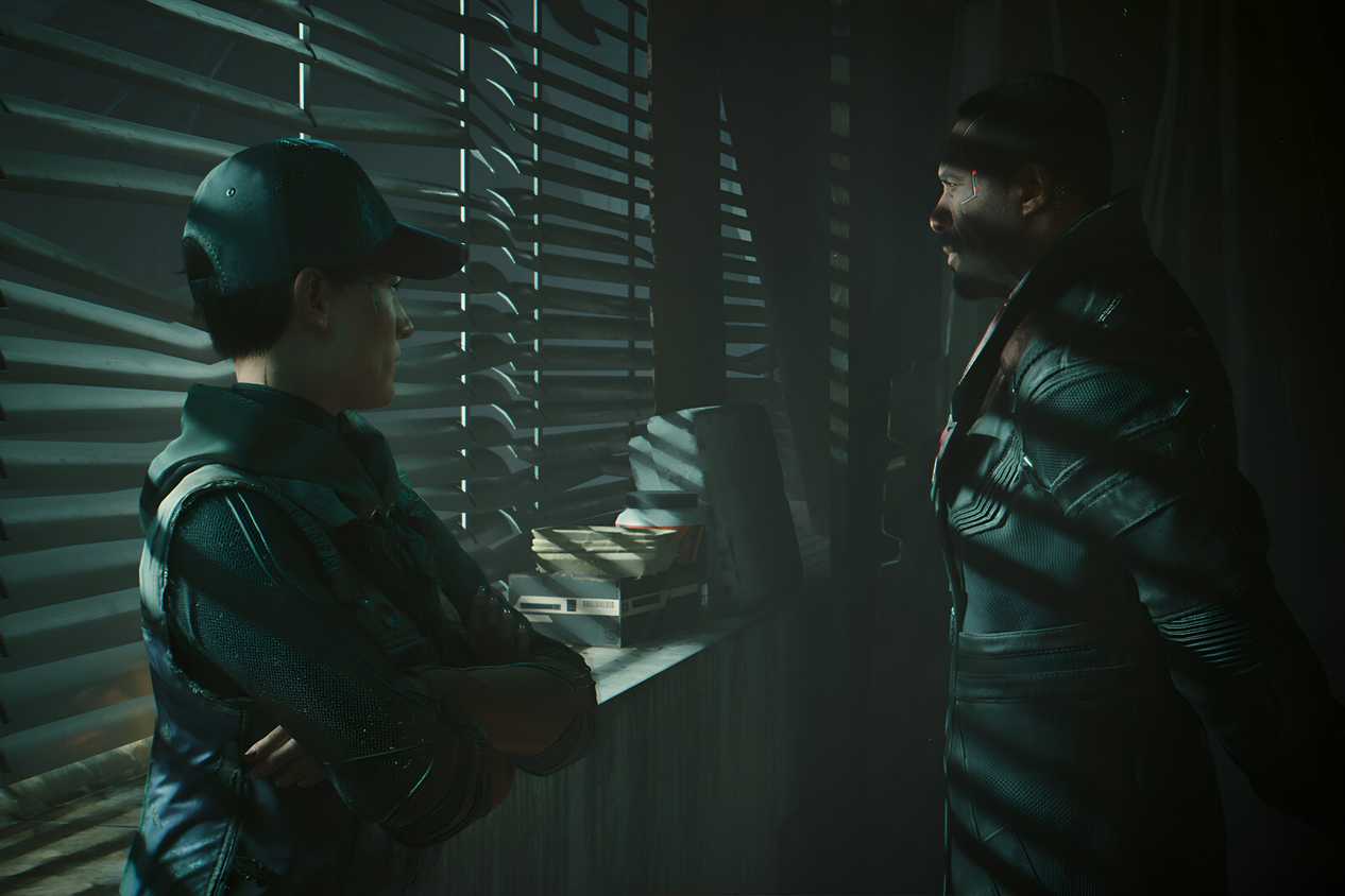 An image from Cyberpunk 2077, showing two characters standing next to a window with the blinds drawn.