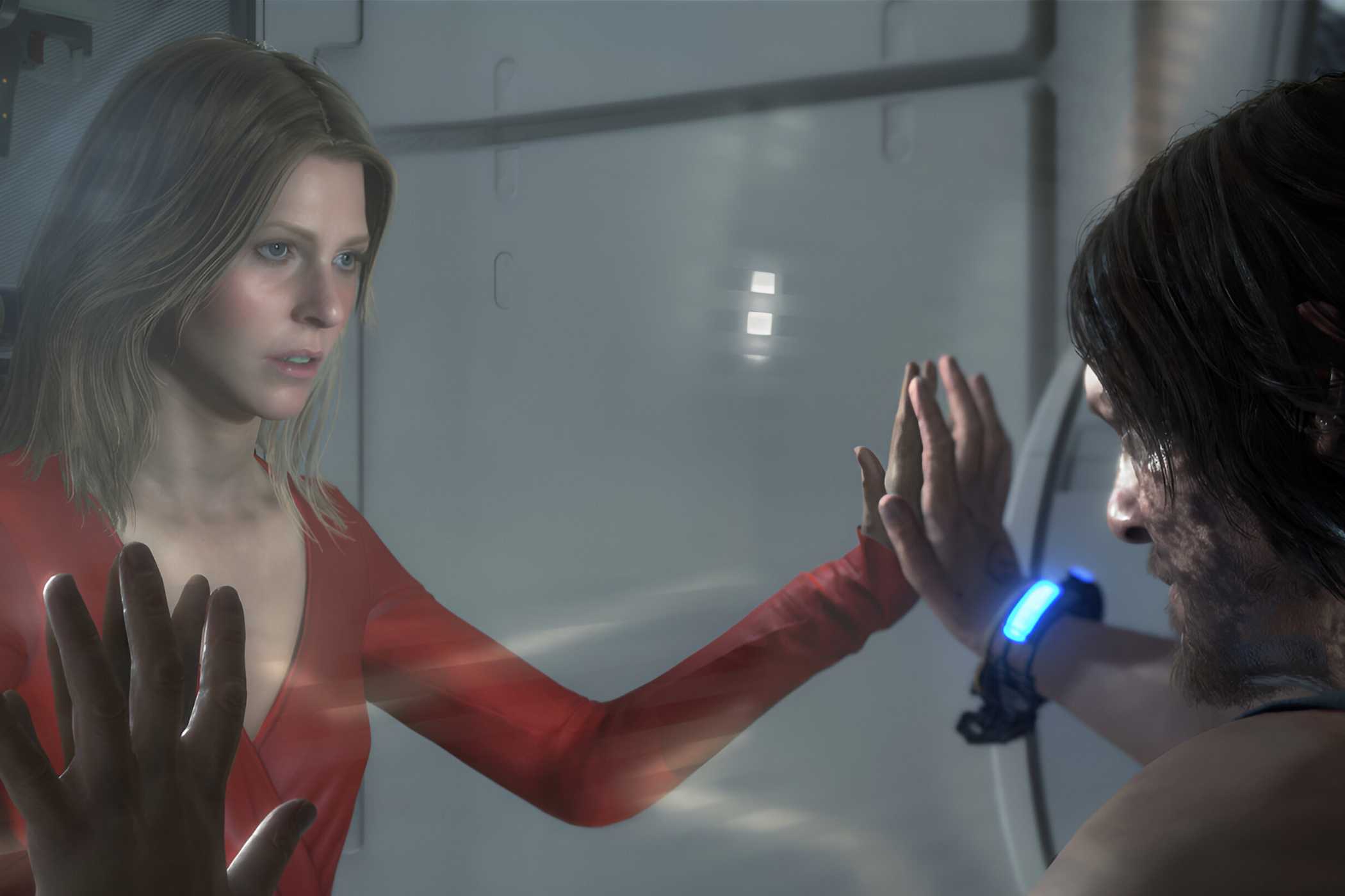 An image from the game "Death Stranding", showing a man and a woman facing each other with a glass wall between them.