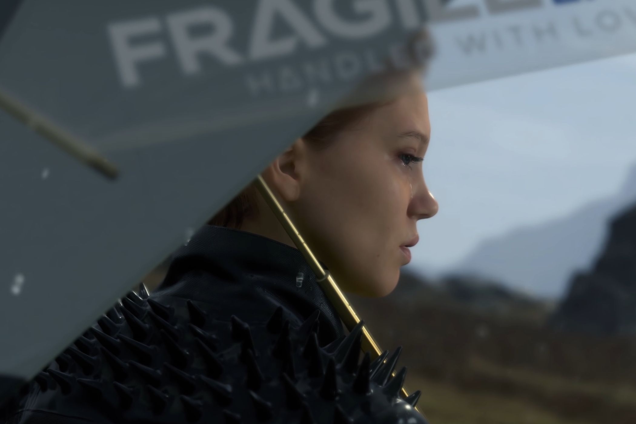 An image from the game "Death Stranding", showing actor Lea Seydoux as Fragile, holding an umbrella.