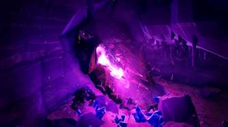 Screenshot from Deep Rock Galactic video game of purple stones illuminating dark mine with bugs all around