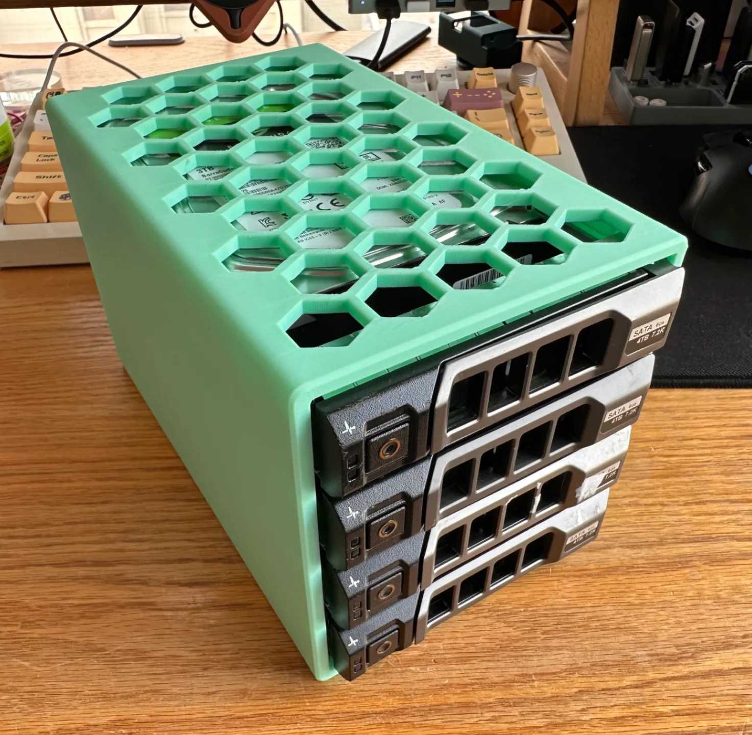 dell hard drive bracket holding found drives lying on a desk against a keyboard