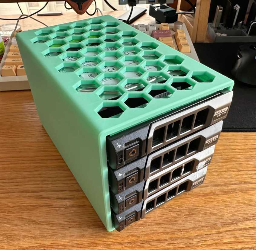 dell hard drive bracket holding found drives lying on a desk against a keyboard