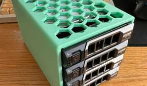 dell hard drive bracket holding found drives lying on a desk against a keyboard