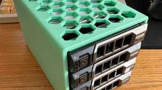dell hard drive bracket holding found drives lying on a desk against a keyboard