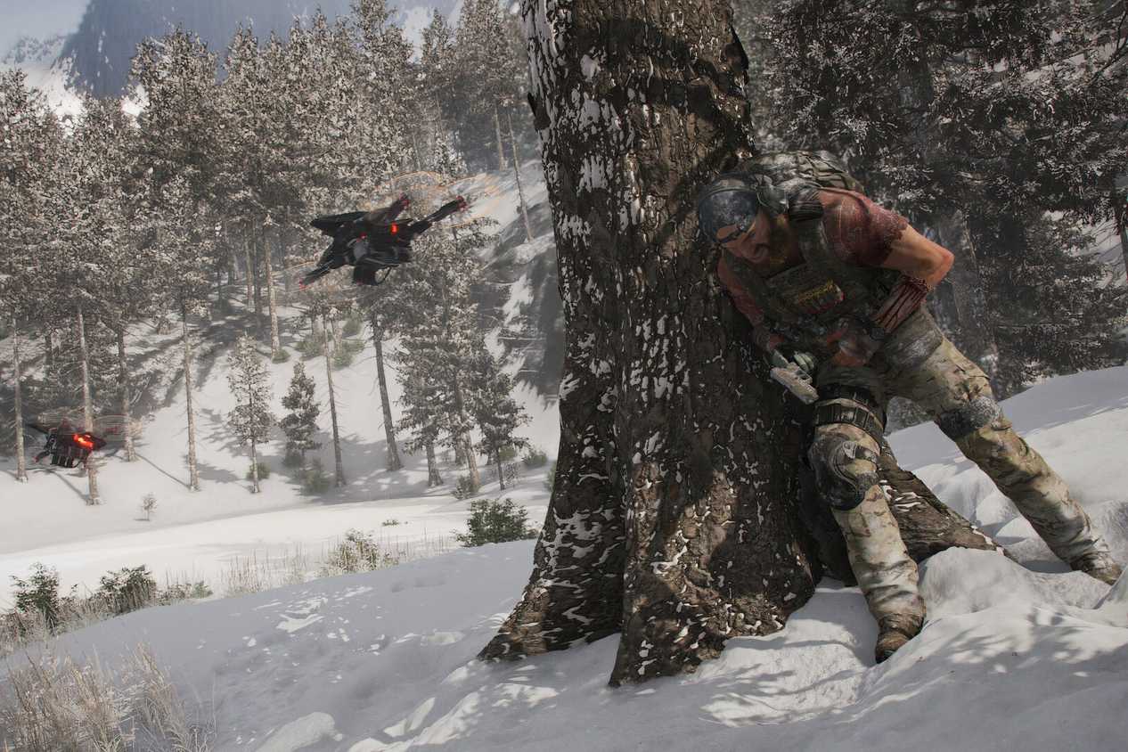 An image from Ghost Recon Breakpoint, showing a person leaning against a tree trunk.