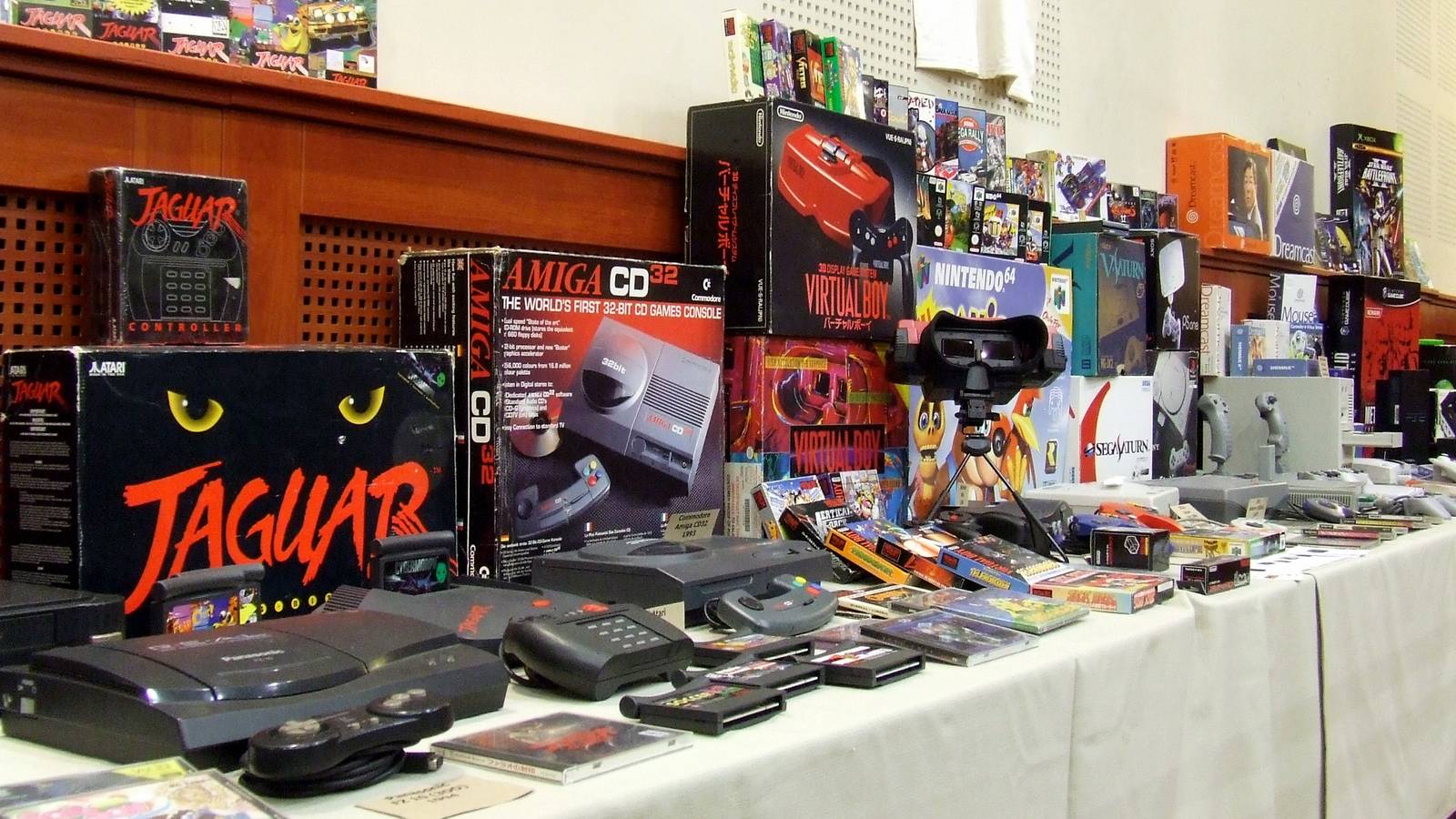 A lot of retro gaming systems, hardware, and games on a table at a Budapest retro gaming event
