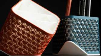 Two Kumiko pen holders of different colors