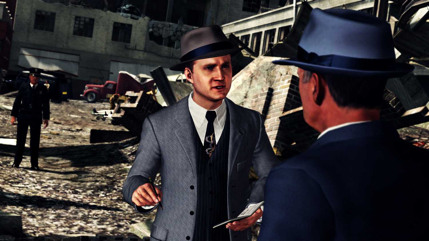 Screenshot from LA Noire video game of two men talking among rubble with a uniformed police officer in the background.
