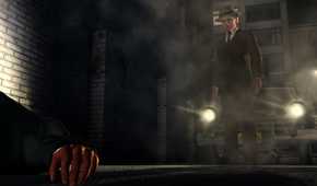 Screenshot from LA Noire video game of man staring at a body on the ground with a car behind him flashing its headlights