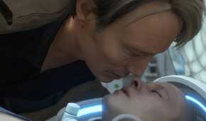 An image from the game "Death Stranding", showing a man leaning over an unconscious person.