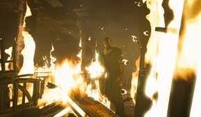 A screenshot from the game Outlast, showing a corridor on fire.