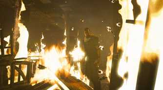 A screenshot from the game Outlast, showing a corridor on fire.