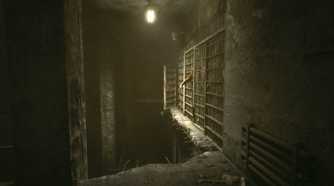 A screenshot from the game Outlast, showing prisoners sticking their hands out from bars.