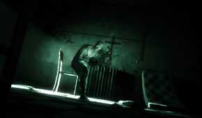 A screenshot from the game Outlast, showing a deranged peson in a nighvision filter.