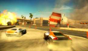 An image from the game "Split Second", showing two cars drift on sand as an airport terminal goes through destruction around them.