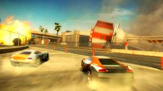 An image from the game "Split Second", showing two cars drift on sand as an airport terminal goes through destruction around them.