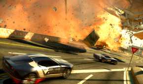 An image from the game "Split Second", showing cars race alongside a stadium while it blows apart and goes up in flames.