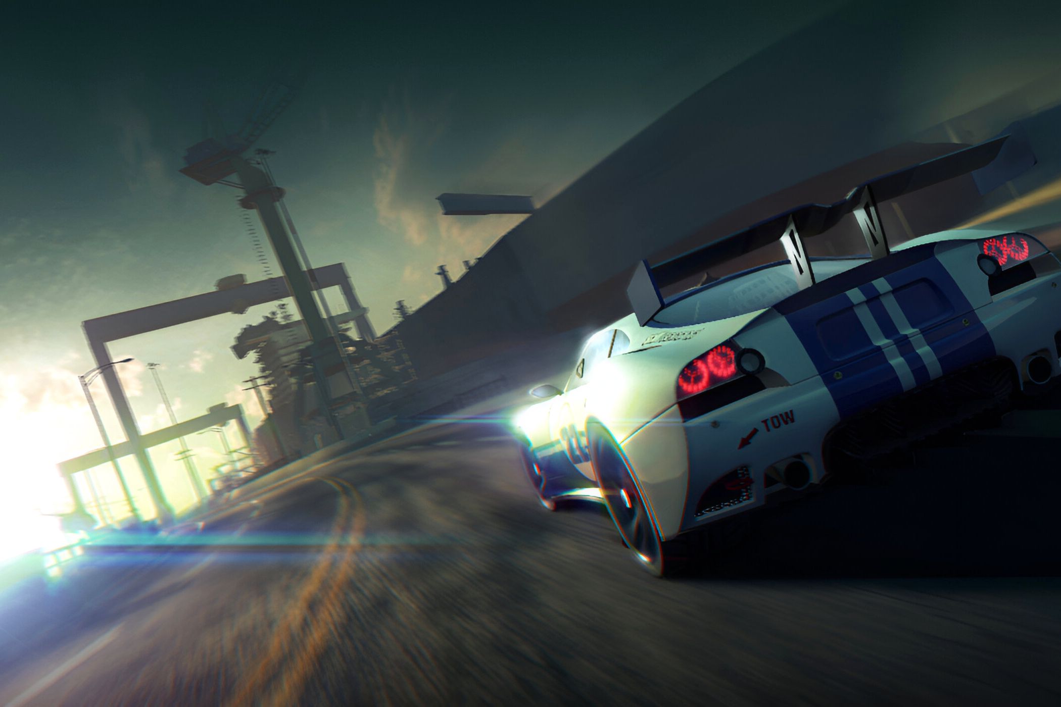 An image from the game "Split Second", showing a white car with blue stripes speeding along a winding road.