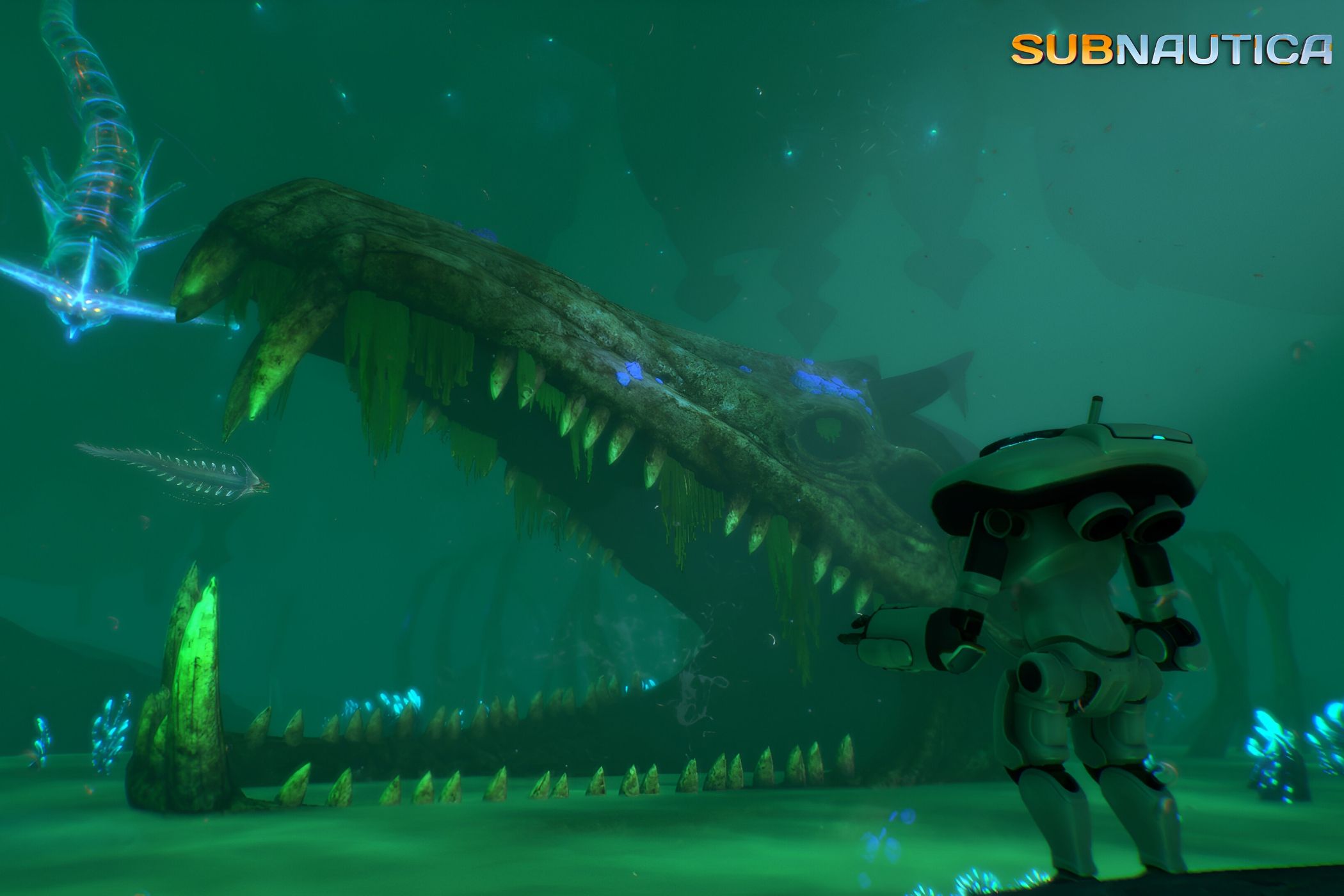 An image from the game "Subnautica", showing the player standing underwater, next to a giant teethy skull.