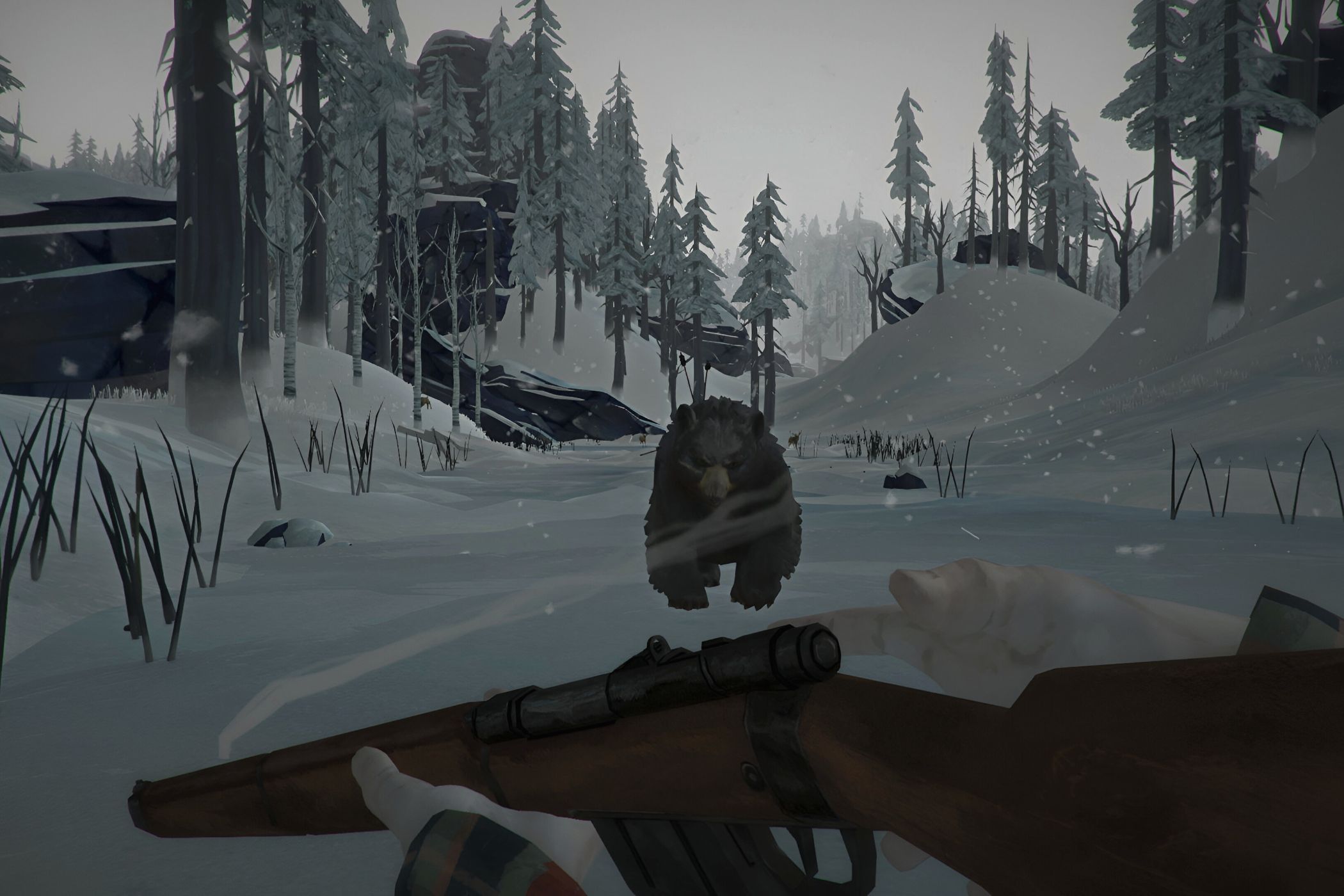 A screenshot from the game "The Long Dark", showing a bear charging towards the screen as cold winds blow around it.