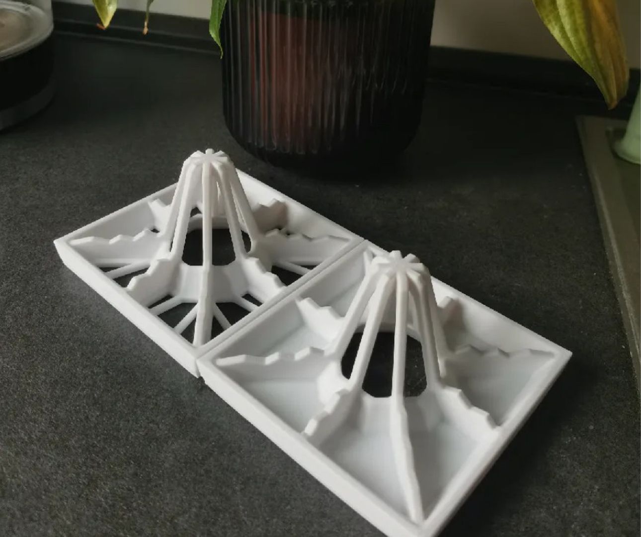 Two drying racks with flower pot behind