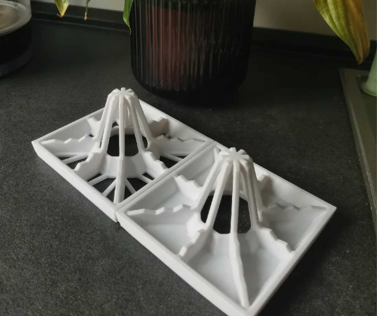 Two drying racks with flower pot behind