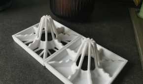 Two drying racks with flower pot behind