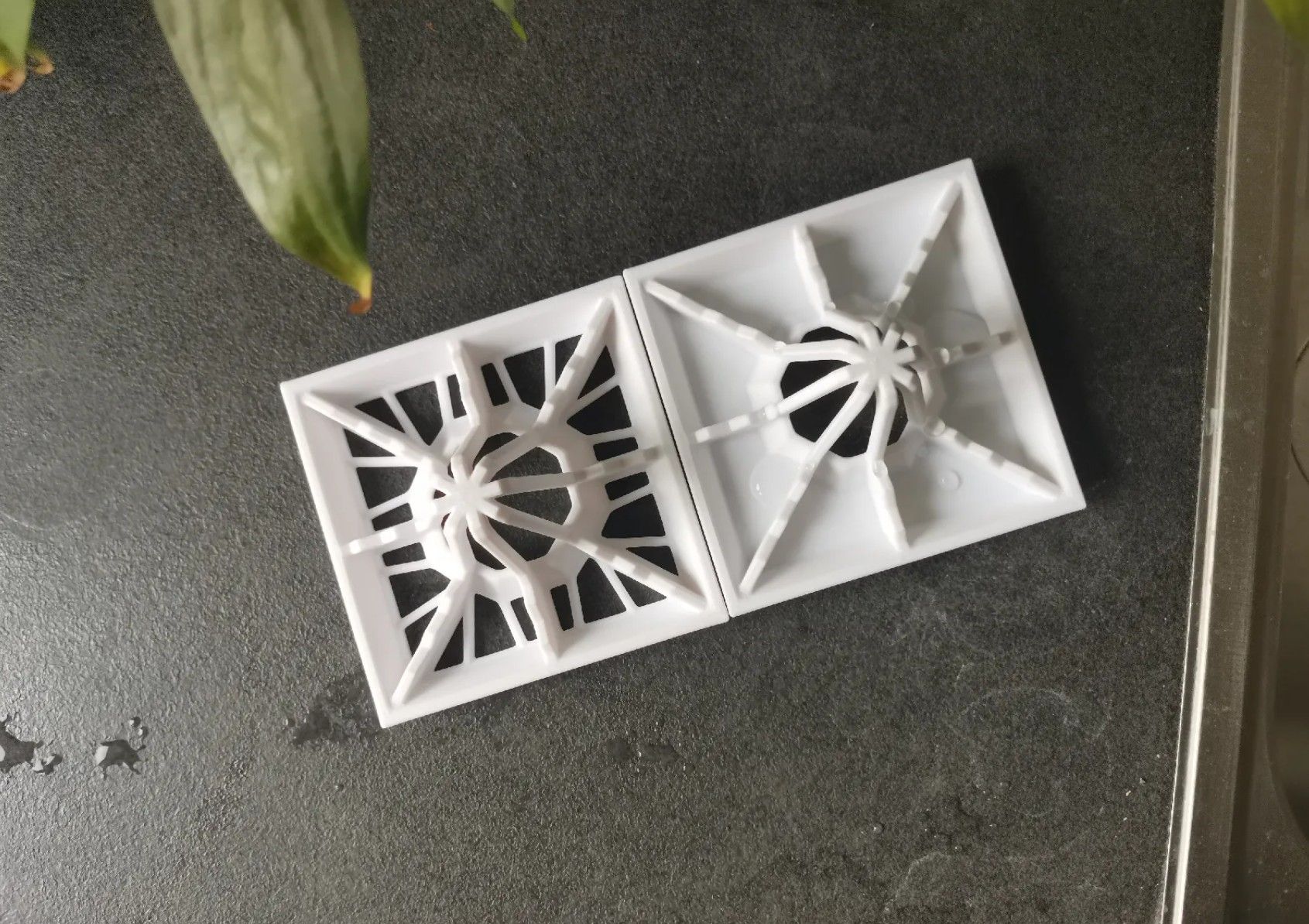 Two similar stackable bottle drying racks on the table