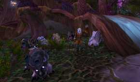 An image from the 2004 game World of Warcraft, showing a forest with huge trees in the night.
