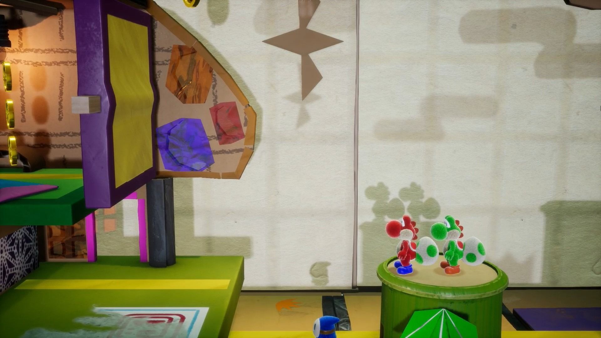 Red and green Yoshi going through level in Yoshi's Crafted World