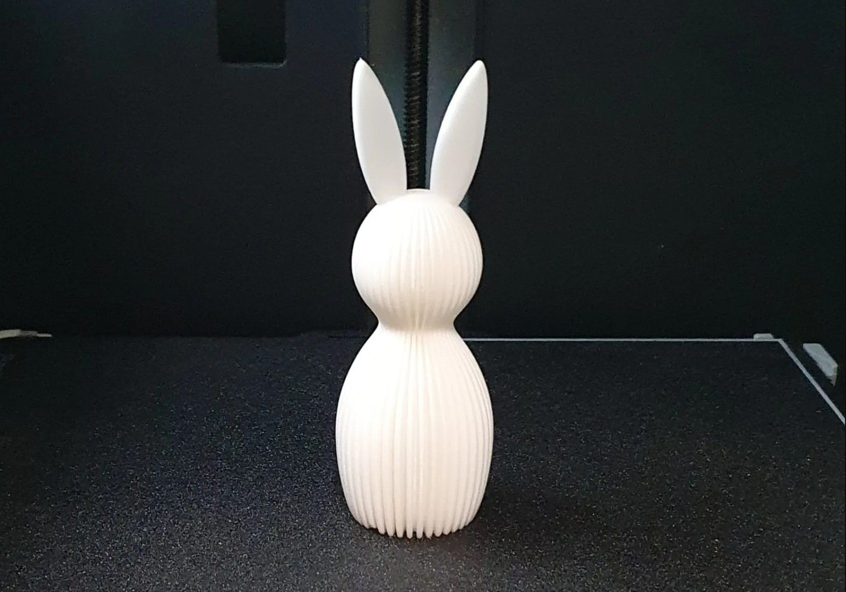 A white easter bunny on a 3D printer bed
