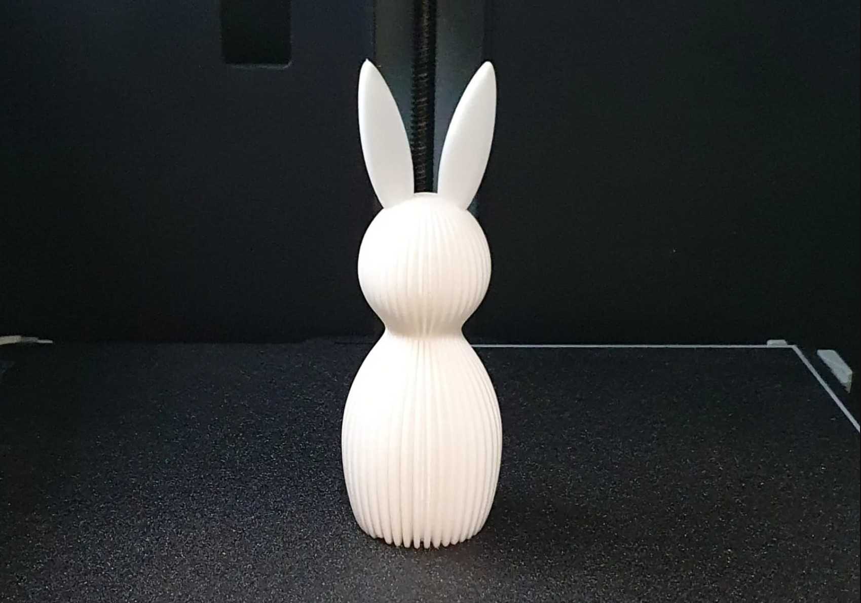 A white easter bunny on a 3D printer bed